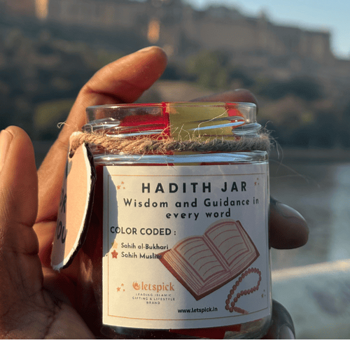 Hand holding a 'Hadith Jar' with a scenic background of a fort.